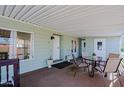 Covered patio with table and chairs, adjacent to the home's entrance at 9501 E Broadway Rd # 140, Mesa, AZ 85208