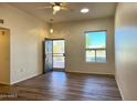 Bright and airy living room featuring light wood-look flooring at 10111 W Thunderbird Blvd, Sun City, AZ 85351