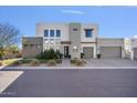 Contemporary two-story house with gray and white exterior at 10929 E North Ln, Scottsdale, AZ 85259