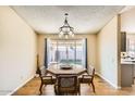 Bright dining area with a large window and wood table at 1243 E Avenida Grande --, Casa Grande, AZ 85122