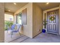 Inviting front porch with two chairs and a decorative wreath at 18749 W San Miguel Ave, Litchfield Park, AZ 85340