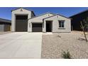 Charming single-story home featuring a neutral color, attached garage, and well-kept landscaping at 47250 W Mellen Ln, Maricopa, AZ 85139