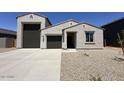 Charming single-story home featuring a three car garage and low maintenance desert landscaping at 47250 W Mellen Ln, Maricopa, AZ 85139
