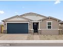 Attractive single-story house with a two-car garage, desert landscaping, and a welcoming front entrance at 4816 N 177Th Ln, Goodyear, AZ 85395
