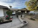 Inviting front entry with brick walkway and rose bushes at 5003 W Mescal St, Glendale, AZ 85304