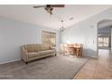 Dining area with light gray walls and a beige couch at 5426 N Rattler Way, Litchfield Park, AZ 85340