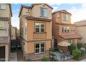 Three-story townhome with private patio and well-manicured landscaping at 7771 W Pipestone Pl, Phoenix, AZ 85035