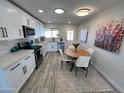 Modern kitchen with white cabinets, stainless steel appliances, and breakfast nook at 8448 E Cambridge Ave, Scottsdale, AZ 85257