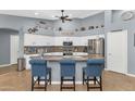 Island kitchen with granite countertops and stainless steel appliances at 8729 W Tonopah Dr, Peoria, AZ 85382