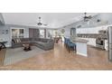 Open floor plan with island kitchen and gray sectional sofa at 8729 W Tonopah Dr, Peoria, AZ 85382