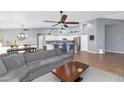 Open floor plan with island kitchen and gray sectional sofa at 8729 W Tonopah Dr, Peoria, AZ 85382