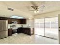 Modern kitchen with stainless steel appliances and dark wood cabinets at 901 N Menze St, Casa Grande, AZ 85122