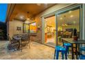 Covered patio featuring outdoor dining with barstool seating and view to the kitchen through pass-through window at 1397 E Verde Blvd, Queen Creek, AZ 85140