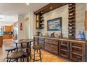 Rustic wet bar with wine storage and seating area at 1397 E Verde Blvd, Queen Creek, AZ 85140