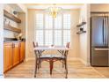 Small dining area with a table and chairs, located near a window with white plantation shutters at 14950 W Mountain View Blvd # 2301, Surprise, AZ 85374