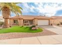 Single-story home with a landscaped front yard, featuring artificial turf and desert landscaping at 15225 W Via Manana Dr, Sun City West, AZ 85375