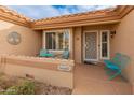 Inviting front entry with a decorative door, a small patio, and colorful seating at 15225 W Via Manana Dr, Sun City West, AZ 85375