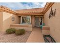 Inviting front entry with a decorative door, a small patio, and colorful seating at 15225 W Via Manana Dr, Sun City West, AZ 85375