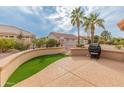 Spacious backyard patio with artificial turf and grill at 15225 W Via Manana Dr, Sun City West, AZ 85375