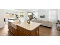 Kitchen island with farmhouse sink, open to living and dining areas at 16780 W Cameron Dr, Surprise, AZ 85388