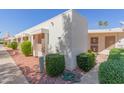 View of a light beige house showing multiple units and landscaping at 17251 N Del Webb Blvd, Sun City, AZ 85373