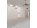 Living room with carpeted floors, ceiling fan, and view of kitchen at 17251 N Del Webb Blvd, Sun City, AZ 85373