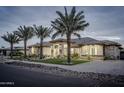 Elegant home with stone accents and landscape lighting at 18145 W Rancho Dr, Litchfield Park, AZ 85340