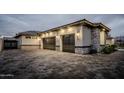 Dark gray three-car garage with stone accents at 18145 W Rancho Dr, Litchfield Park, AZ 85340