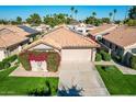 Aerial view of a tan house with a tile roof and landscaping at 19111 N 94Th Ave, Peoria, AZ 85382