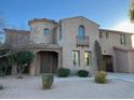 Two-story house with arched entryway and balcony at 20391 E Via Del Oro Dr, Queen Creek, AZ 85142