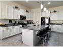 Modern kitchen with white cabinets, island, and stainless steel appliances at 20496 W Valley View Dr, Buckeye, AZ 85396