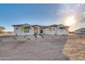 Single-story home with stone accents and a tile roof.Landscaped yard with walkway at 22859 W Euclid Ave, Buckeye, AZ 85326