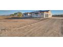 View of the home's exterior, driveway and landscaping at 22859 W Euclid Ave, Buckeye, AZ 85326