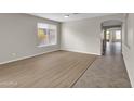 Bright living room featuring light wood-look floors and neutral walls at 2706 N 115Th Dr, Avondale, AZ 85392