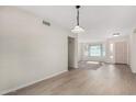 Bright dining room with light wood floors and access to the living room at 2728 E Encanto Cir, Mesa, AZ 85213