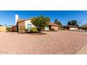 Ranch house with a tree in front and a gravel yard at 2728 E Encanto Cir, Mesa, AZ 85213