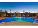 Expansive pool and spa with fire features and desert landscaping at 29512 N Tarragona Dr, Peoria, AZ 85383