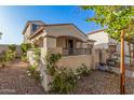 House with stucco siding, a covered entryway and landscaping at 3040 N Point Ridge Rd, Buckeye, AZ 85396