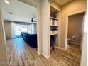 Bright hallway with built-in shelving and powder room at 3094 N 195Th Dr, Buckeye, AZ 85396