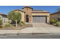 Brick home with a two-car garage and landscaped front yard at 316 E Leverenz Ave, Queen Creek, AZ 85140