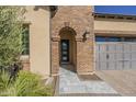 Elegant front entry with a brick archway and tile walkway at 316 E Leverenz Ave, Queen Creek, AZ 85140