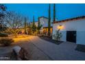 Landscaped pathway leading to the home's entrance at night at 32633 N 137Th St, Scottsdale, AZ 85262