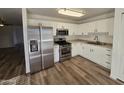 Bright kitchen with stainless steel appliances and wood-look flooring at 3408 W Mclellan Blvd, Phoenix, AZ 85017