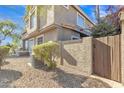 Back exterior view, showing a wooden gate and AC unit at 4102 E Ray Rd # 1006, Phoenix, AZ 85044