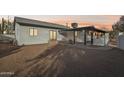 View of the home's back, showcasing a covered patio and landscaping at 4205 E Peak View Rd, Cave Creek, AZ 85331