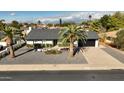 Single-level home with a modern, black garage door and nicely landscaped yard at 4916 E Kathleen Rd, Scottsdale, AZ 85254