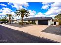 Bright white exterior with black accents and palm trees at 4916 E Kathleen Rd, Scottsdale, AZ 85254