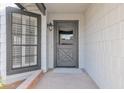 Gray front door with a wood-like design and sidelights at 5344 W Desert Hills Dr, Glendale, AZ 85304