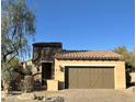 Single-story home with a two-car garage and desert landscaping at 6231 E Mark Way # 32, Cave Creek, AZ 85331