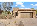 Front view of a charming home with a two-car garage and drought-tolerant landscaping at 6231 E Mark Way # 32, Cave Creek, AZ 85331